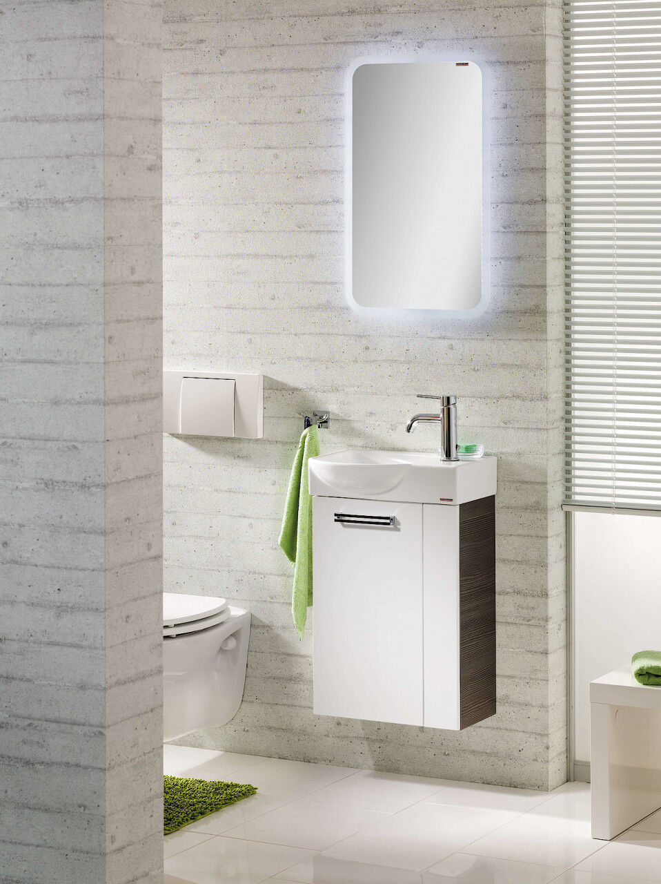 Weißes Gäste-WC mit Toilette, LED-Spiegel und Waschbecken-Unterschrank.